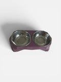 Pet food bowl with two stainless steel bowls on a purple base against a white background