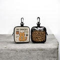 Two small pouches with cat illustrations on a gray surface