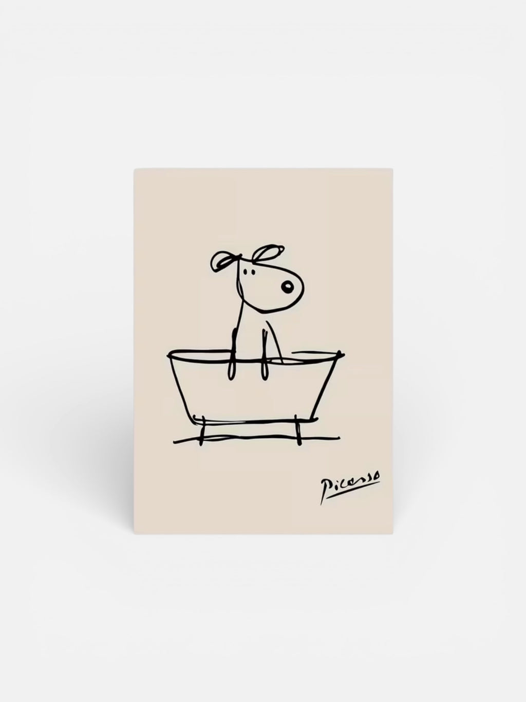 Beige notepad with a black line drawing of a dog in a bathtub, signed 'Picasso', on a white background.