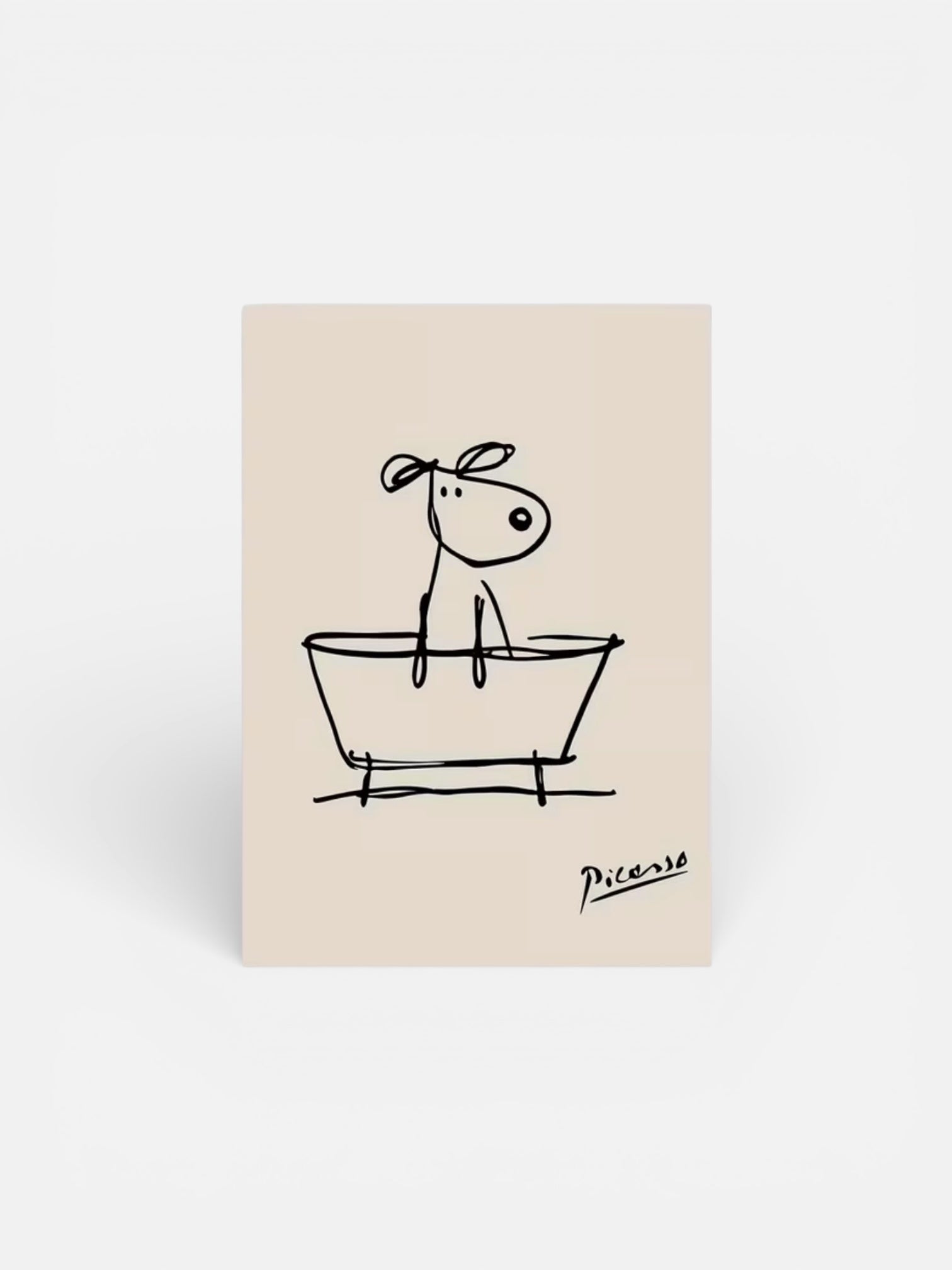 Beige notepad with a black line drawing of a dog in a bathtub, signed 'Picasso', on a white background.