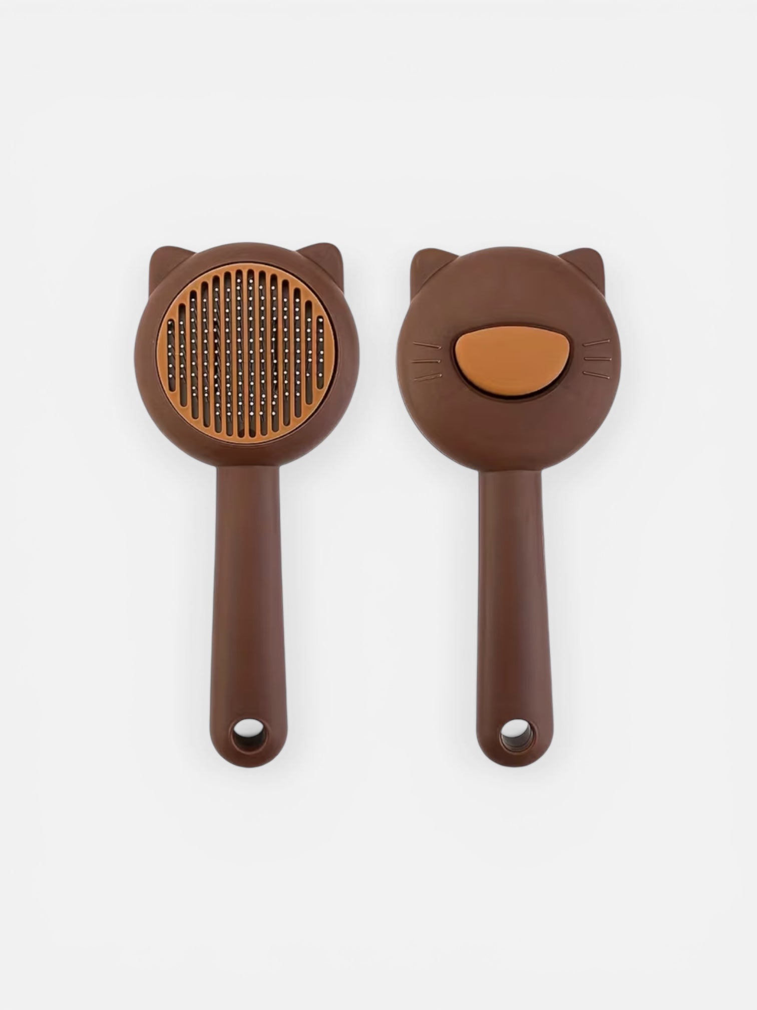 Brown pet grooming brush with cat face design on a white background