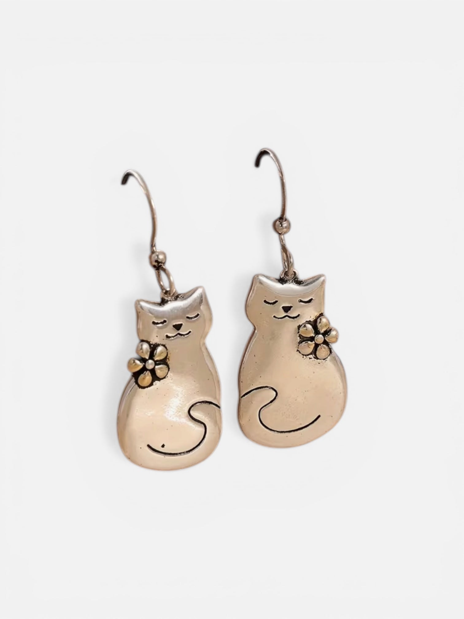 Cat-shaped earrings with floral details on a white background
