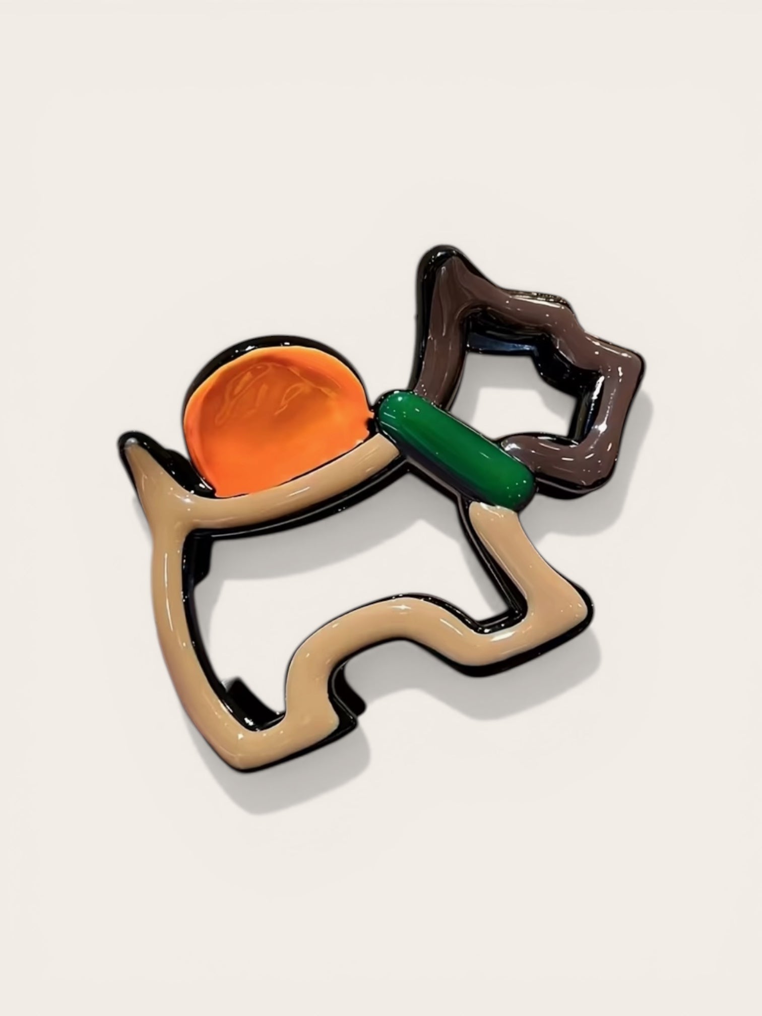 Dog-shaped cookie cutter with a carrot on a beige background