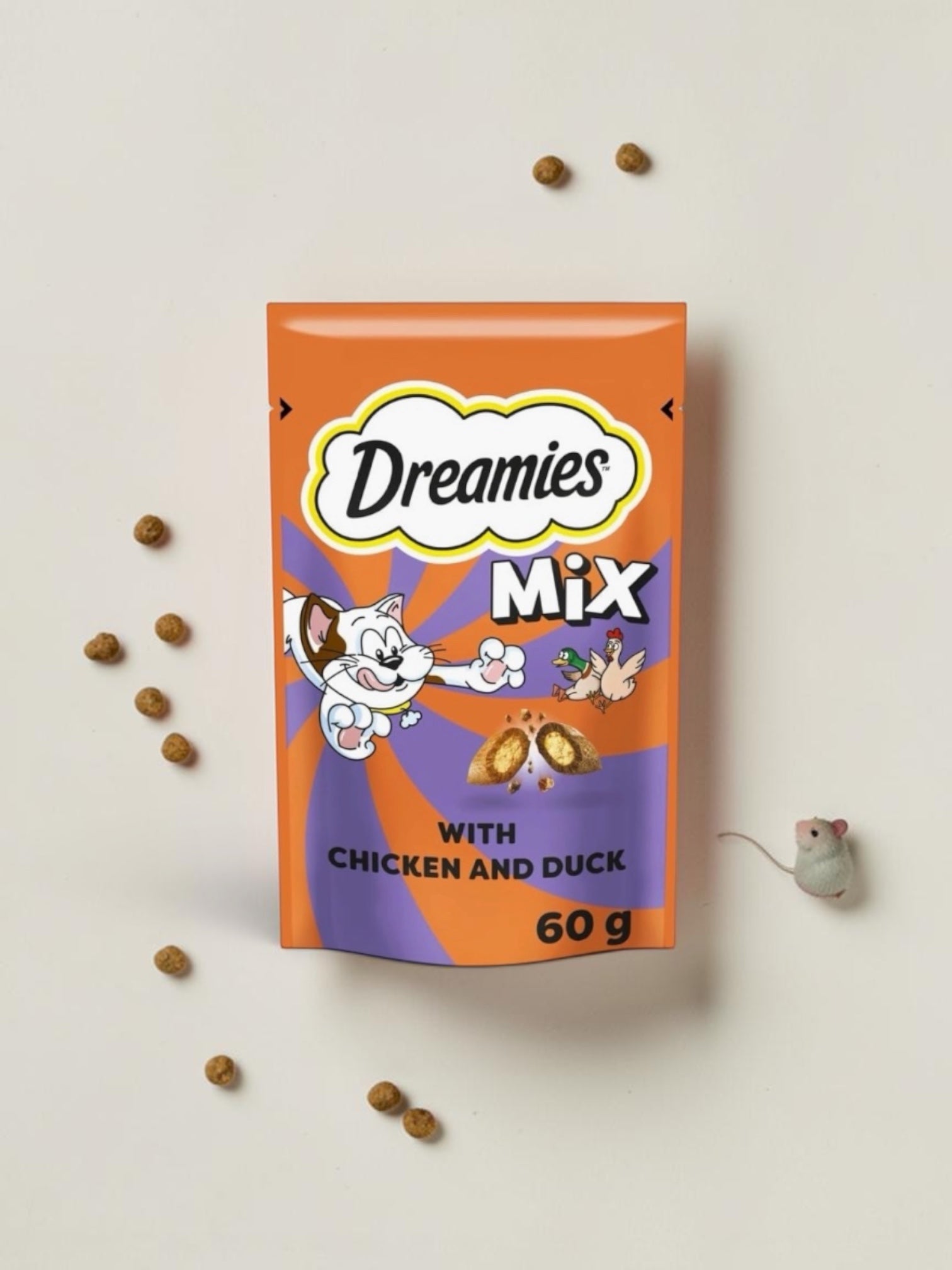 Dreamies Mix cat food packet with scattered treats on a light background